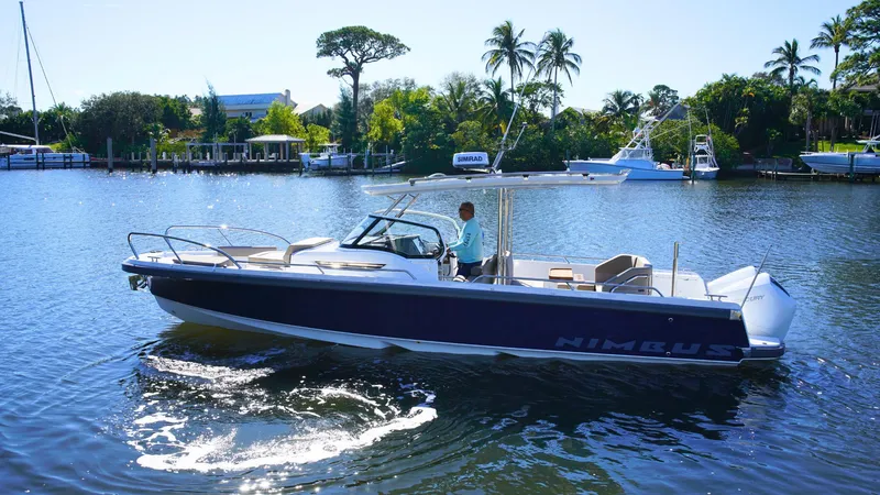 Slide: The Image of Nimbus T9 #165 boat cruising on a sunny lake, 2025 model. - 1