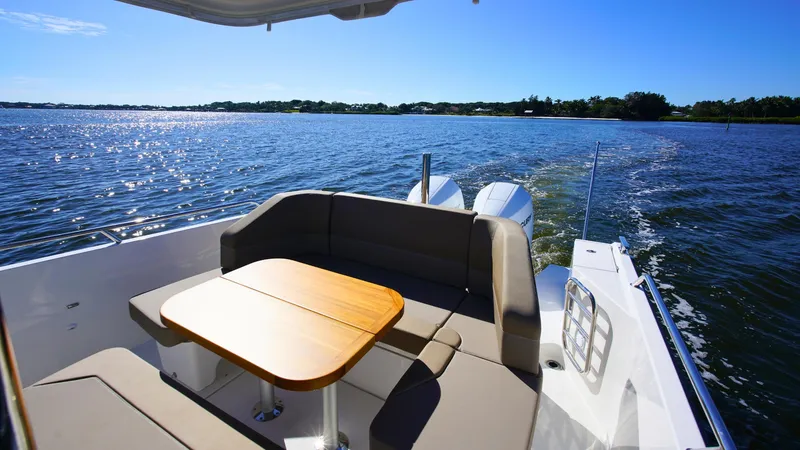 Slide: The Image of Nimbus T9 #165 boat, 2025 model, with seating and table on a sunny lake. - 13
