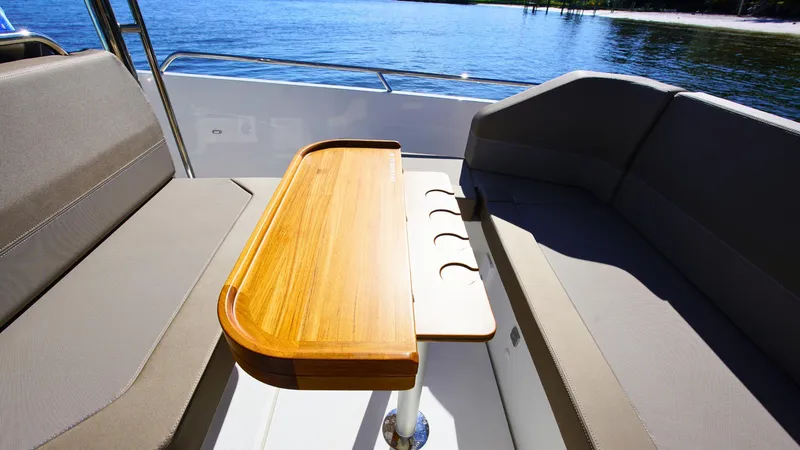 Slide: The Image of Luxurious seating area on Nimbus T9 #165 boat, featuring a sleek wooden table, 2025 model. - 16