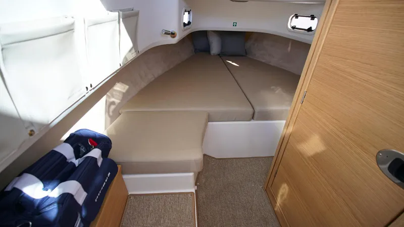 Slide: The Image of Cozy cabin interior of 2025 Nimbus T9 #165 with beige cushions and wooden accents. - 19
