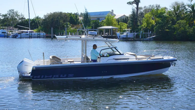 Slide: The Image of Nimbus T9 #165 boat cruising on a serene river, 2025 model. - 2