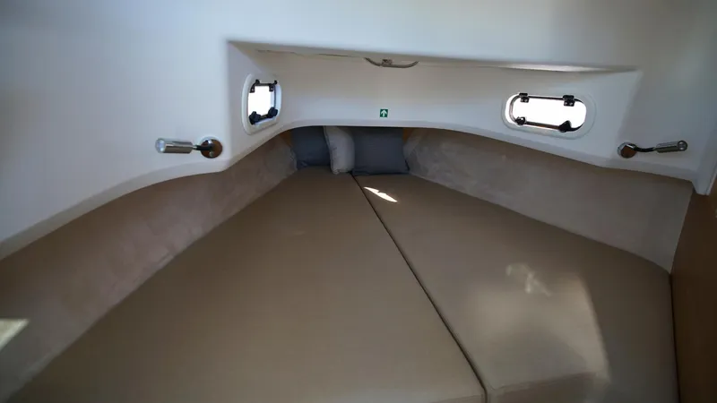 Slide: The Image of Nimbus T9 #165 2025 cabin interior with beige cushions and small windows. - 20