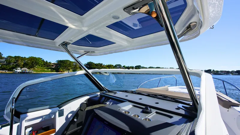 Slide: The Image of Interior view of Nimbus T9 #165 boat, showcasing modern dashboard and panoramic water scenery. - 5
