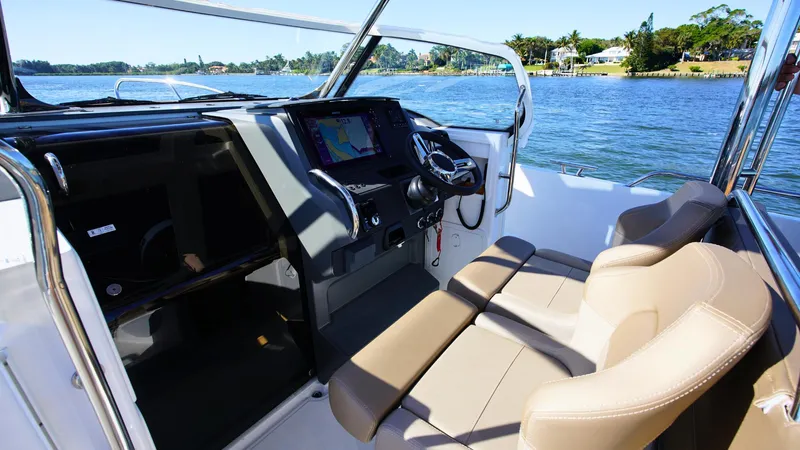 Slide: The Image of Interior of 2025 Nimbus T9 #165 boat with modern dashboard and seating. - 7