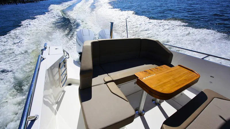 Slide: The Image of Nimbus T9 #165 boat interior with seating and table, cruising on open water, 2025 model. - 9