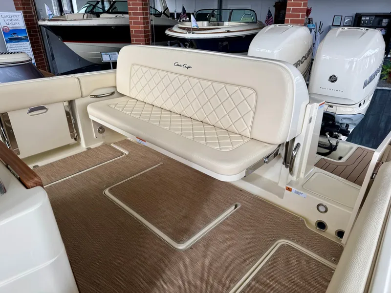 Slide: The Image of 2022 Chris-Craft Catalina 30 boat interior with beige seating and twin outboard engines. - 32