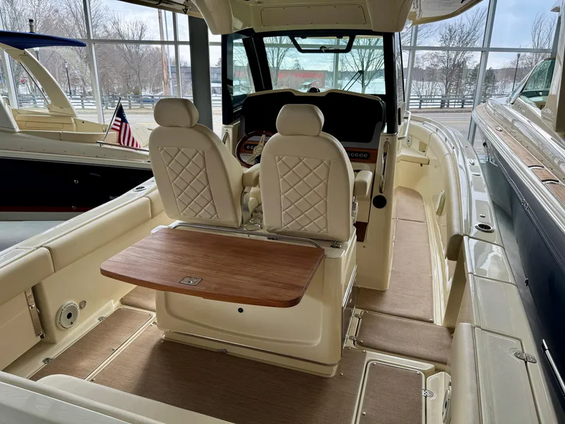 Slide: The Image of 2022 Chris-Craft Catalina 30 interior with elegant seating and wooden table. - 33