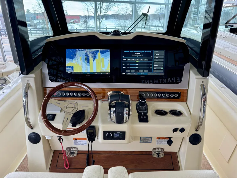 Slide: The Image of 2022 Chris-Craft Catalina 30 helm with navigation screens and controls. - 36
