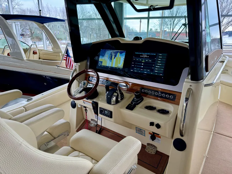 Slide: The Image of 2022 Chris-Craft Catalina 30 helm with modern navigation display and luxurious seating. - 37