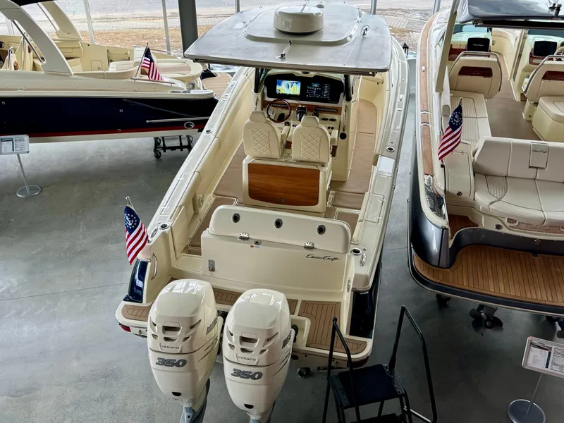 Slide: The Image of 2022 Chris-Craft Catalina 30 boat with dual engines, American flags, and luxury seating. - 44