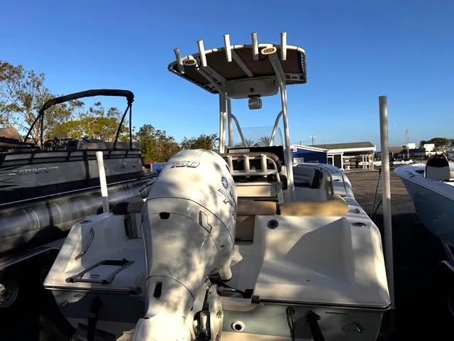 Slide: The Image of 2022 Tidewater 210 LXF boat with outboard motor, docked under clear blue sky. - 5