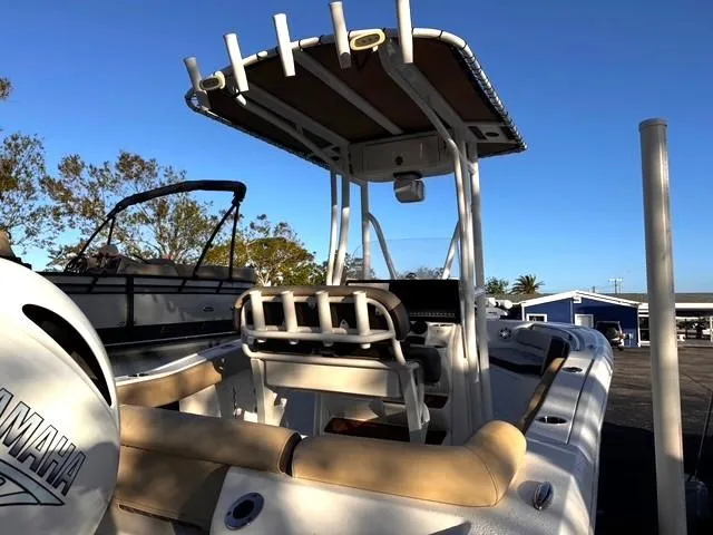Slide: The Image of 2022 Tidewater 210 LXF boat with Yamaha engine, docked under clear blue sky. - 6