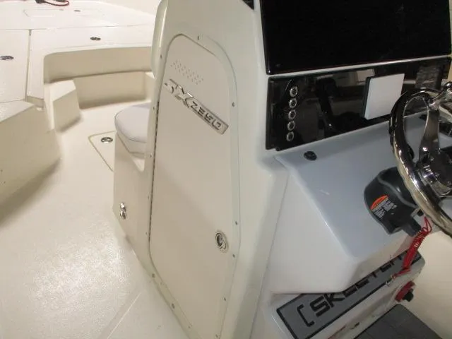 Slide: The Image of 2025 Skeeter SX2350 boat interior with steering console and seating area. - 5