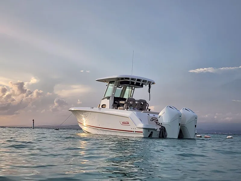 Slide: The Image of 2023 Boston Whaler 250 Outrage boat on calm water at sunset. - 11