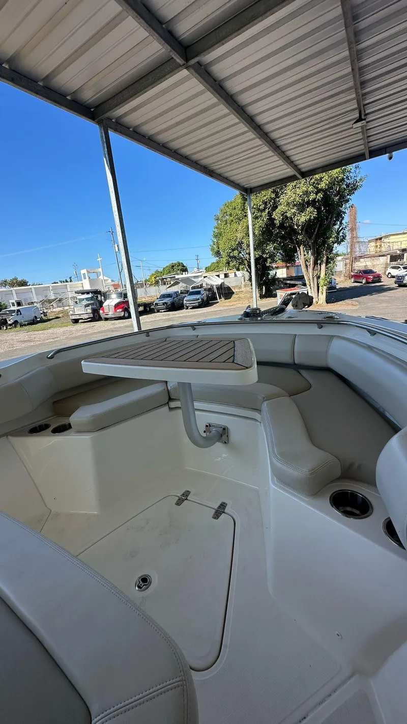 Slide: The Image of 2023 Boston Whaler 250 Outrage boat interior under a metal canopy. - 14