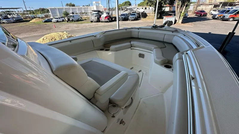 Slide: The Image of 2023 Boston Whaler 250 Outrage boat interior with cushioned seating and cup holders. - 16