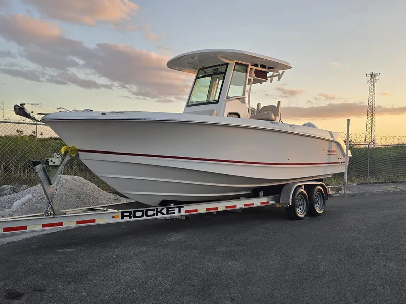 Slide: The Image of 2023 Boston Whaler 250 Outrage boat on a trailer at sunset. - 3