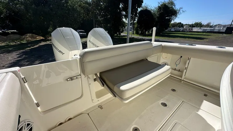 Slide: The Image of 2023 Boston Whaler 250 Outrage boat interior with seating and dual Mercury engines. - 5