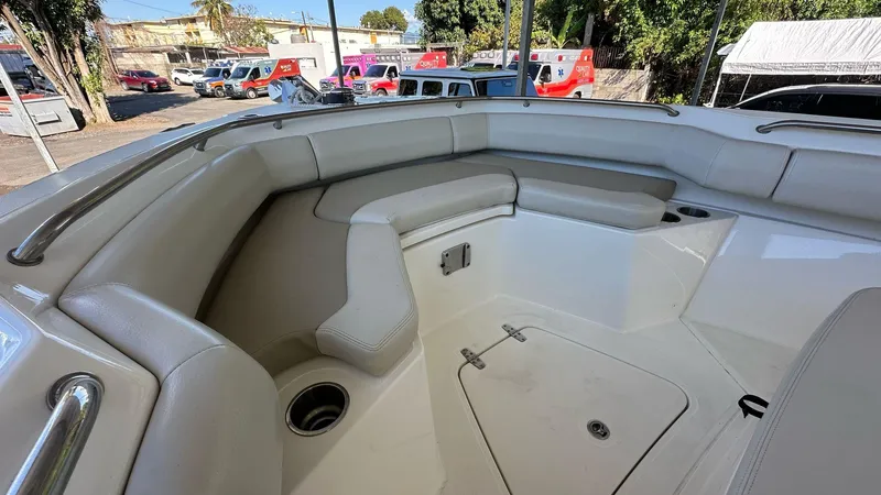 Slide: The Image of 2023 Boston Whaler 250 Outrage boat interior with cushioned seating and storage. - 9