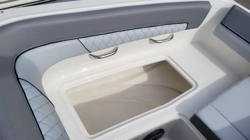 Slide: The Image of 2025 Bayliner D22 boat interior with cushioned seating and storage compartment. - 20
