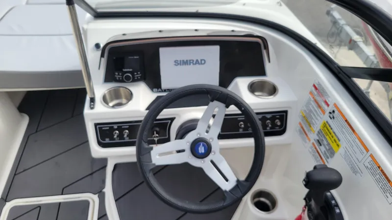 Slide: The Image of 2025 Bayliner D22 boat dashboard with steering wheel and Simrad display. - 31