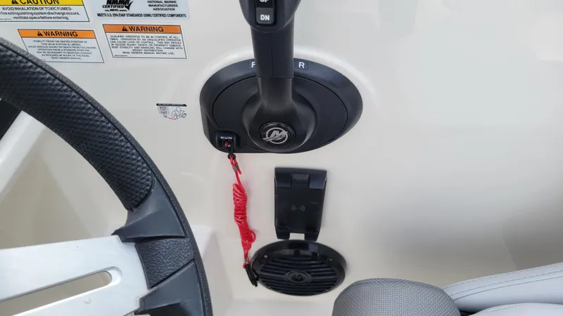 Slide: The Image of 2025 Bayliner D22 boat controls with steering wheel and throttle lever. - 39