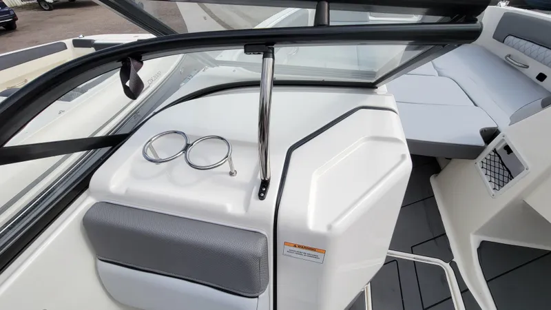 Slide: The Image of 2025 Bayliner D22 boat interior with windshield, seating, and cup holders. - 42