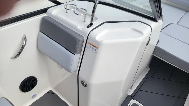 Slide: The Image of 2025 Bayliner D22 boat interior with sleek white console and gray seating. - 43
