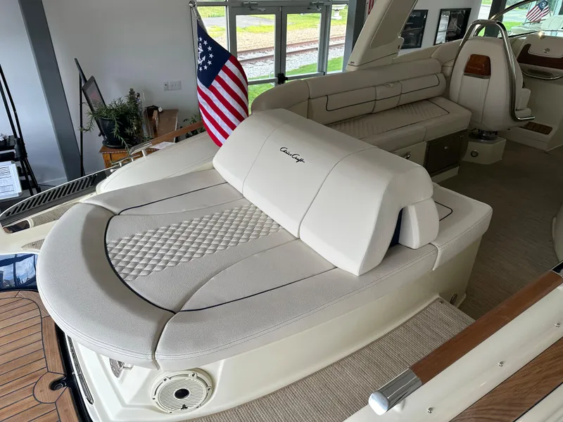 Slide: The Image of 2024 Chris-Craft Launch 28 GT interior with beige seating and American flag. - 22