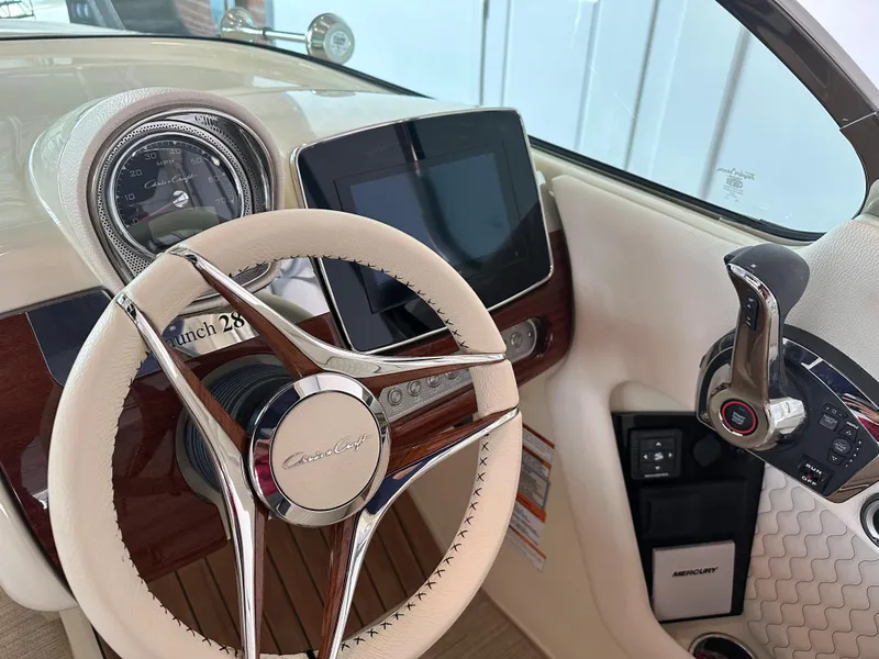 Slide: The Image of 2024 Chris-Craft Launch 28 GT dashboard with steering wheel and digital display. - 25