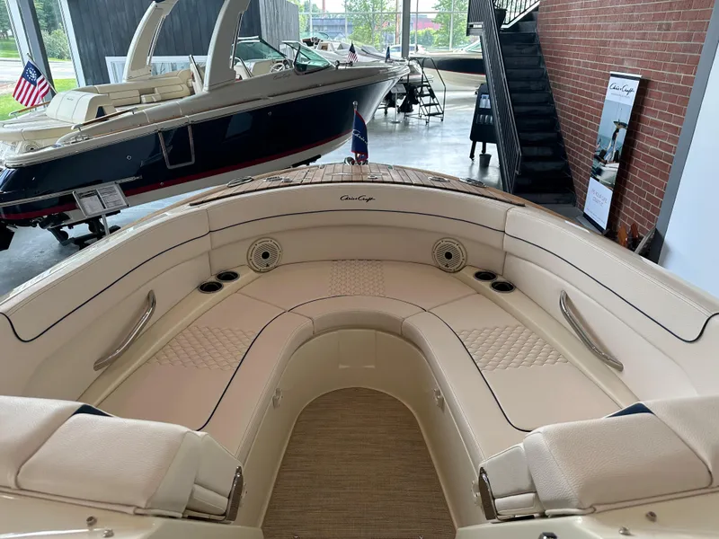 Slide: The Image of 2024 Chris-Craft Launch 28 GT boat interior with luxurious seating in showroom. - 26