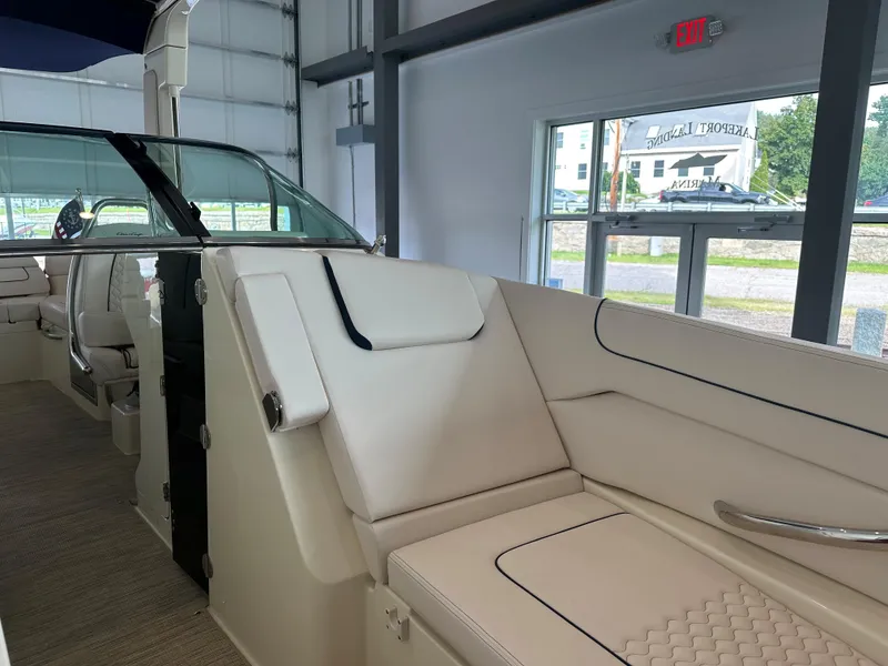 Slide: The Image of 2024 Chris-Craft Launch 28 GT interior with elegant white seating in a showroom. - 29