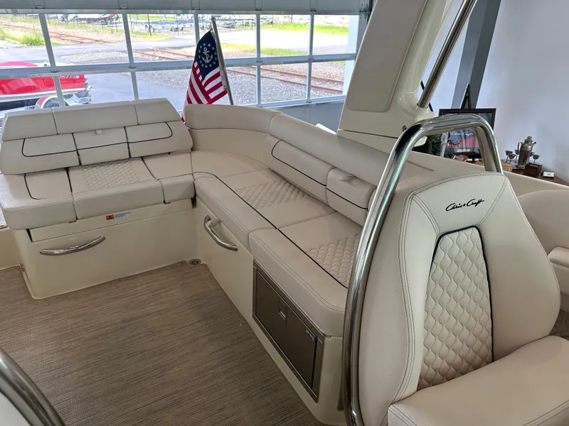 Slide: The Image of Luxurious interior of 2024 Chris-Craft Launch 28 GT with elegant seating and American flag. - 33