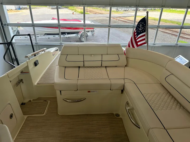 Slide: The Image of 2024 Chris-Craft Launch 28 GT interior with American flag, luxurious seating, and elegant design. - 34