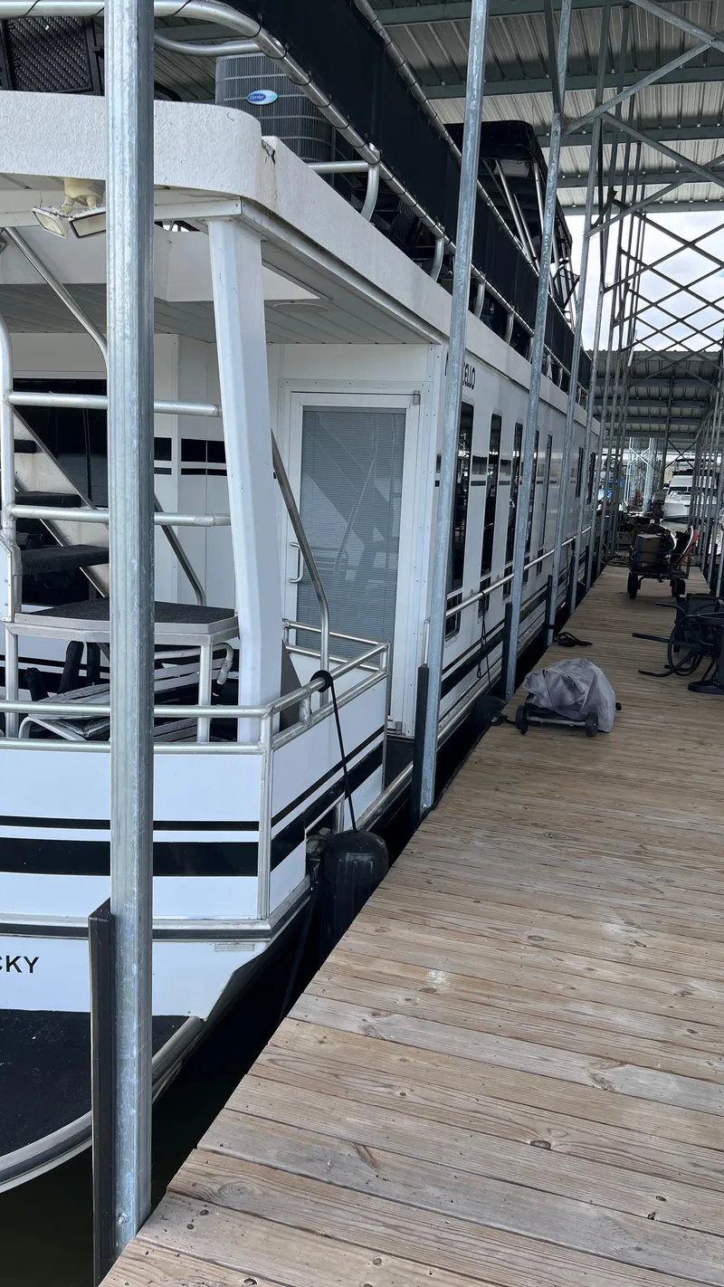 Slide: The Image of 2008 Monticello River Yacht docked at a marina, side view. - 12