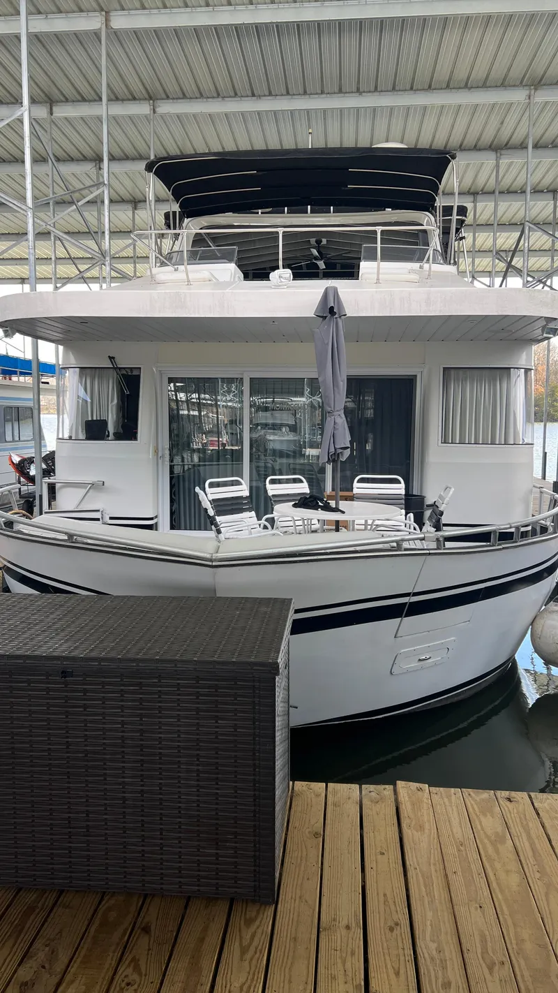 Slide: The Image of 2008 Monticello River Yacht docked with outdoor seating and covered upper deck. - 14