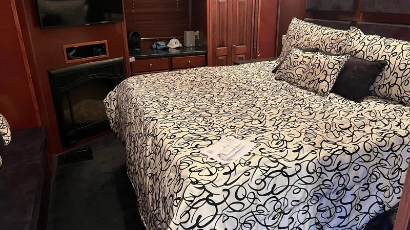 Slide: The Image of Luxurious bedroom in 2008 Monticello River Yacht with elegant bedding and fireplace. - 15