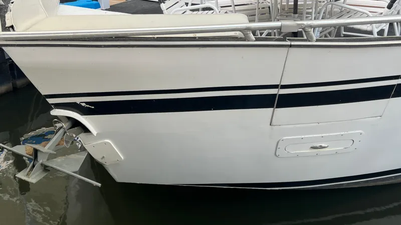 Slide: The Image of 2008 Monticello River Yacht, side view with anchor, docked in water. - 20