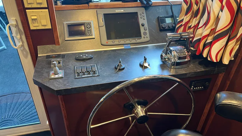 Slide: The Image of Control panel of a 2008 Monticello River Yacht with steering wheel and navigation equipment. - 22