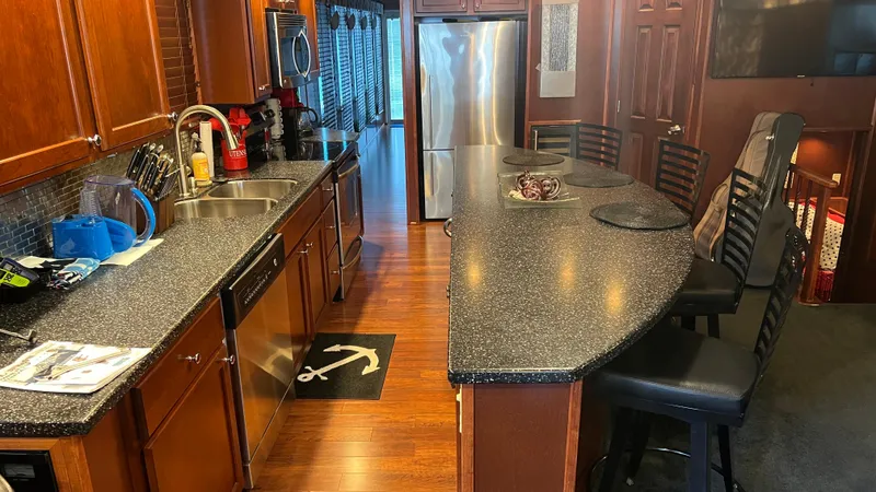 Slide: The Image of Luxurious kitchen interior of 2008 Monticello River Yacht with modern appliances and seating. - 23