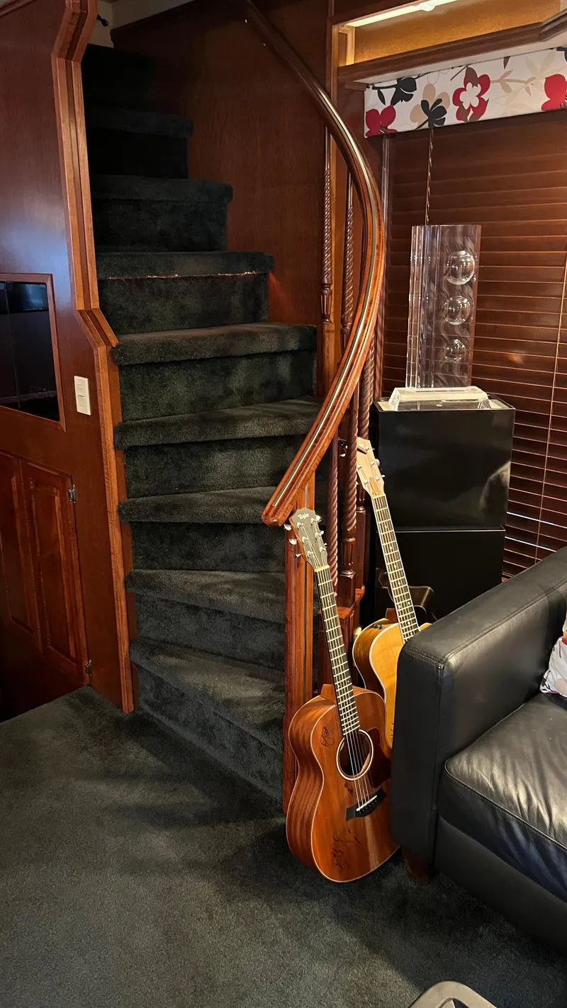 Slide: The Image of Interior of 2008 Monticello River Yacht with guitars by a spiral staircase. - 28