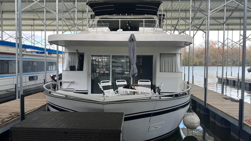 Slide: The Image of 2008 Monticello River Yacht docked in a marina, featuring outdoor seating and covered deck. - 3