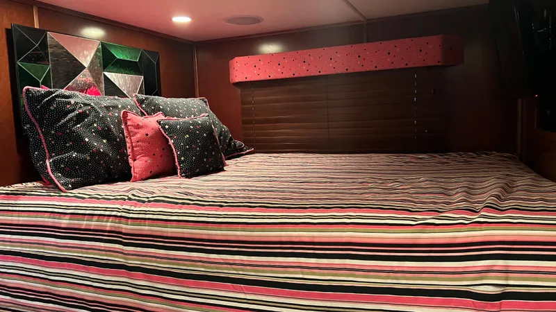 Slide: The Image of Luxurious bedroom interior of 2008 Monticello River Yacht with striped bedding and decorative pillows. - 31