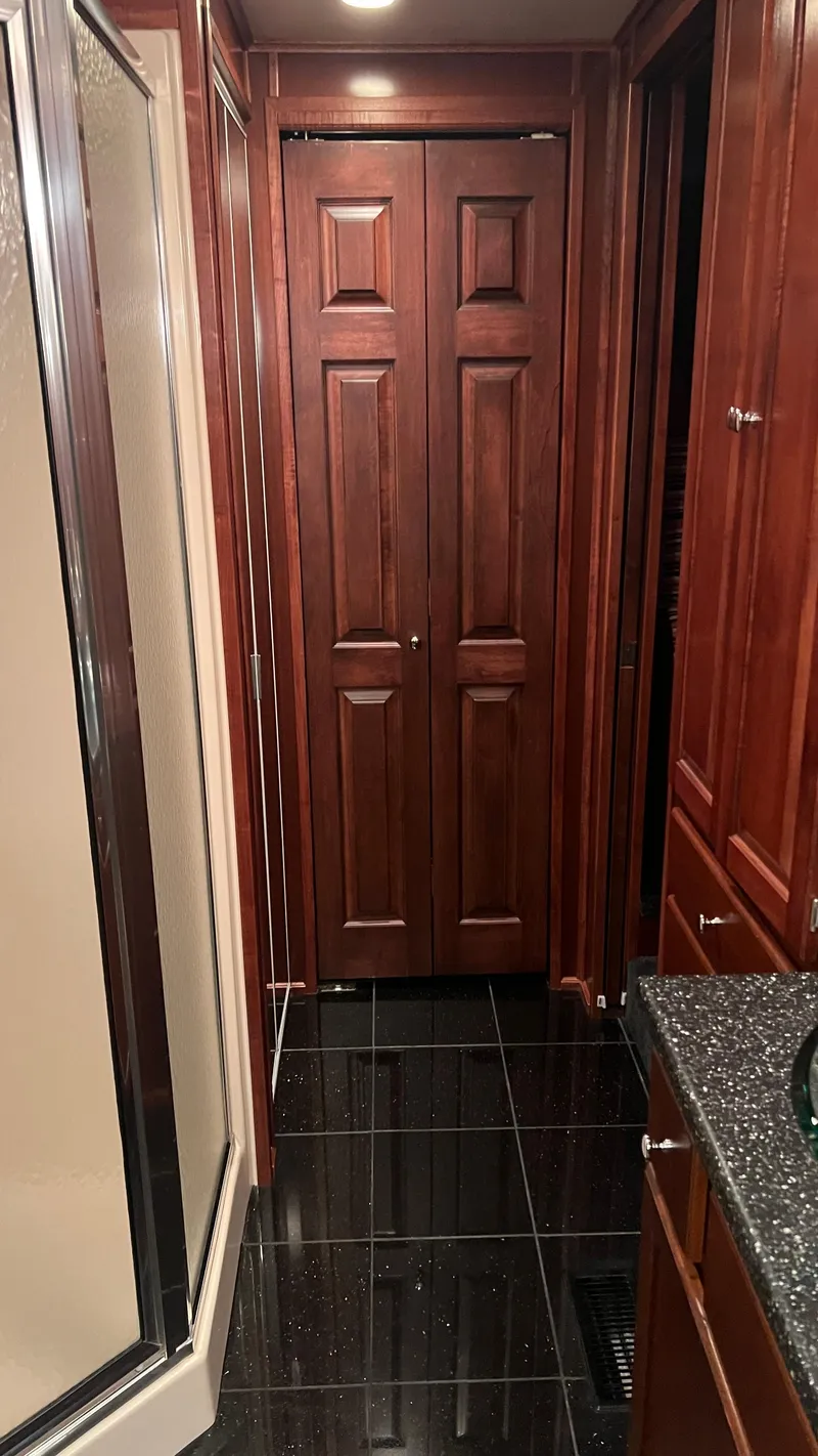 Slide: The Image of Luxurious 2008 Monticello River Yacht interior with elegant wood cabinetry and sleek black flooring. - 35