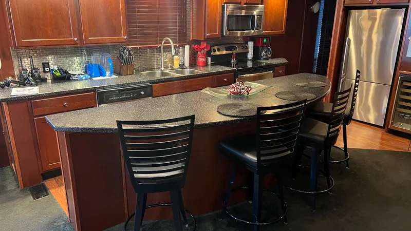 Slide: The Image of Luxurious kitchen interior on 2008 Monticello River Yacht with modern appliances and seating. - 4