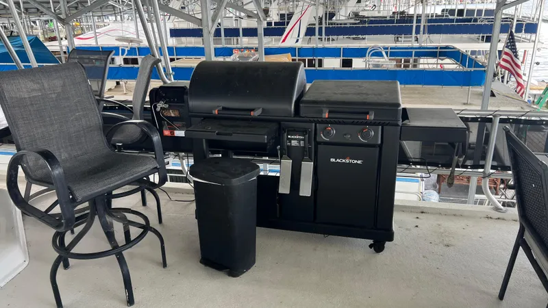 Slide: The Image of Blackstone grill on Monticello River Yacht, 2008 model, with patio chairs nearby. - 42