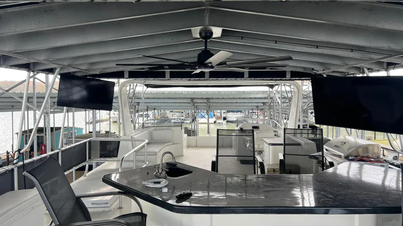 Slide: The Image of Luxurious 2008 Monticello River Yacht interior with bar, seating, and dual TVs. - 43