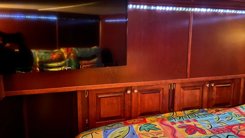 Slide: The Image of Luxurious 2008 Monticello River Yacht interior with wood paneling and vibrant bedding. - 47
