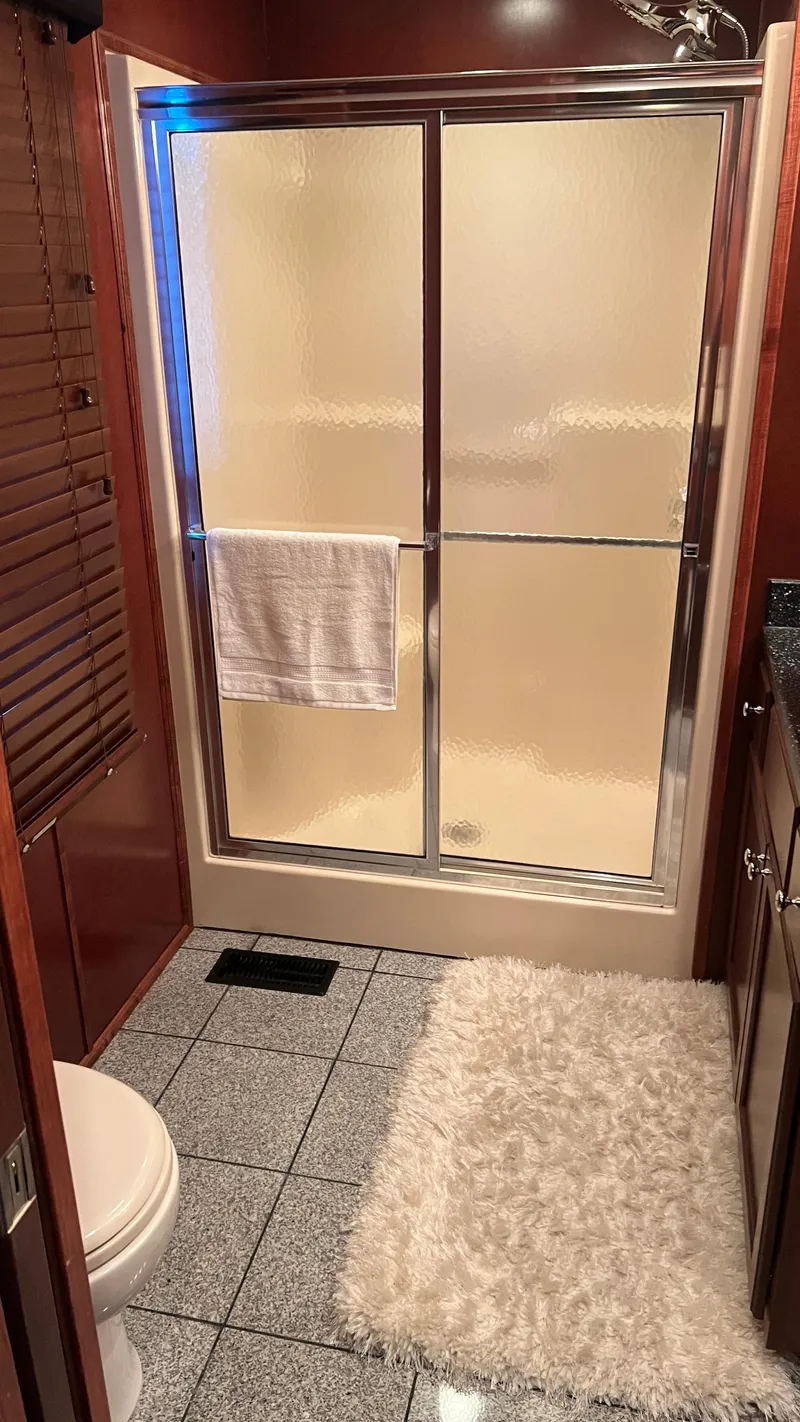Slide: The Image of Luxurious bathroom in 2008 Monticello River Yacht with shower, toilet, and plush rug. - 50