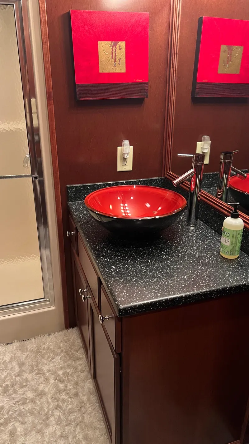 Slide: The Image of Luxurious bathroom in 2008 Monticello River Yacht with red vessel sink and modern decor. - 51